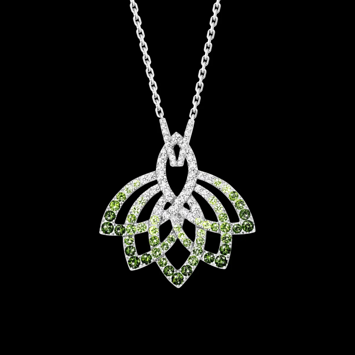 Garrard Lotus Flower pendant with tsavorites and diamonds in 18K white gold on a black background